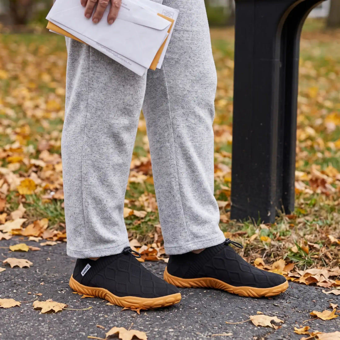 Black Nimbao Cloud Walk knit slip-ons shown in a separate official lifestyle image