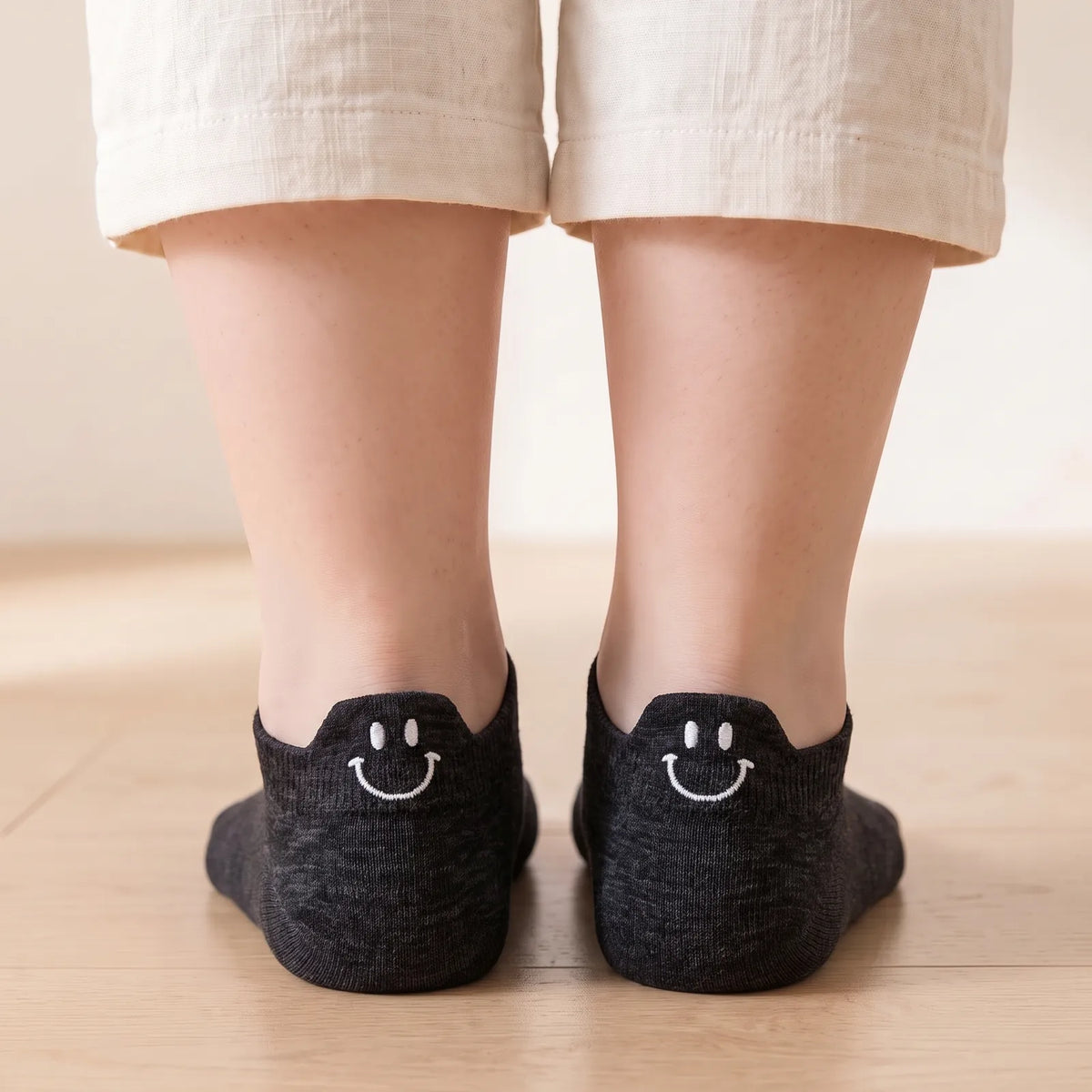 Black smile ankle socks worn